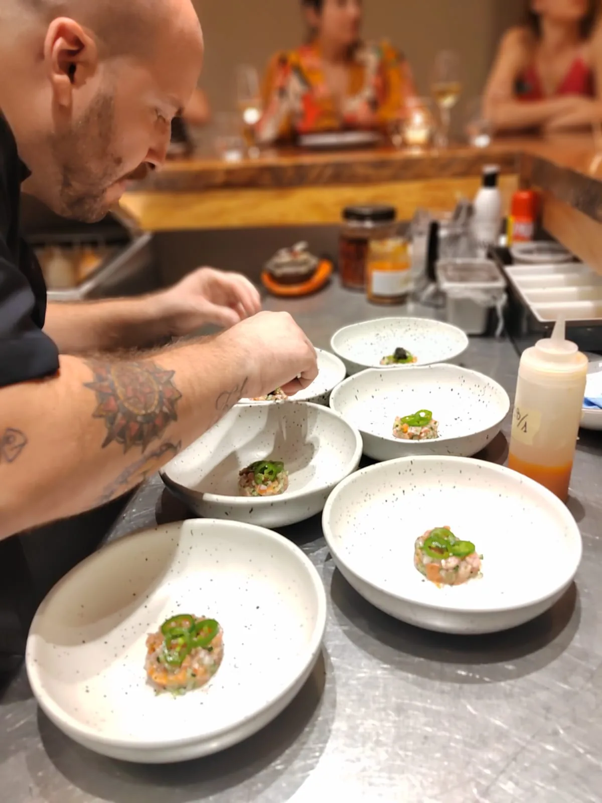 Chef finishing several dishes for a catered dinner