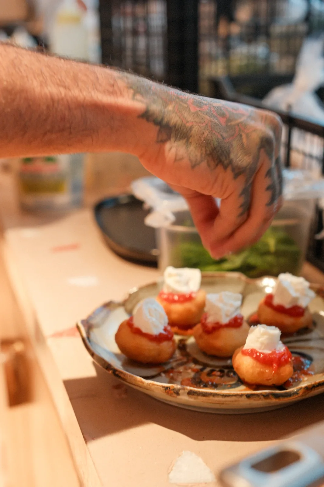 A chef carefully finishing an appetizer