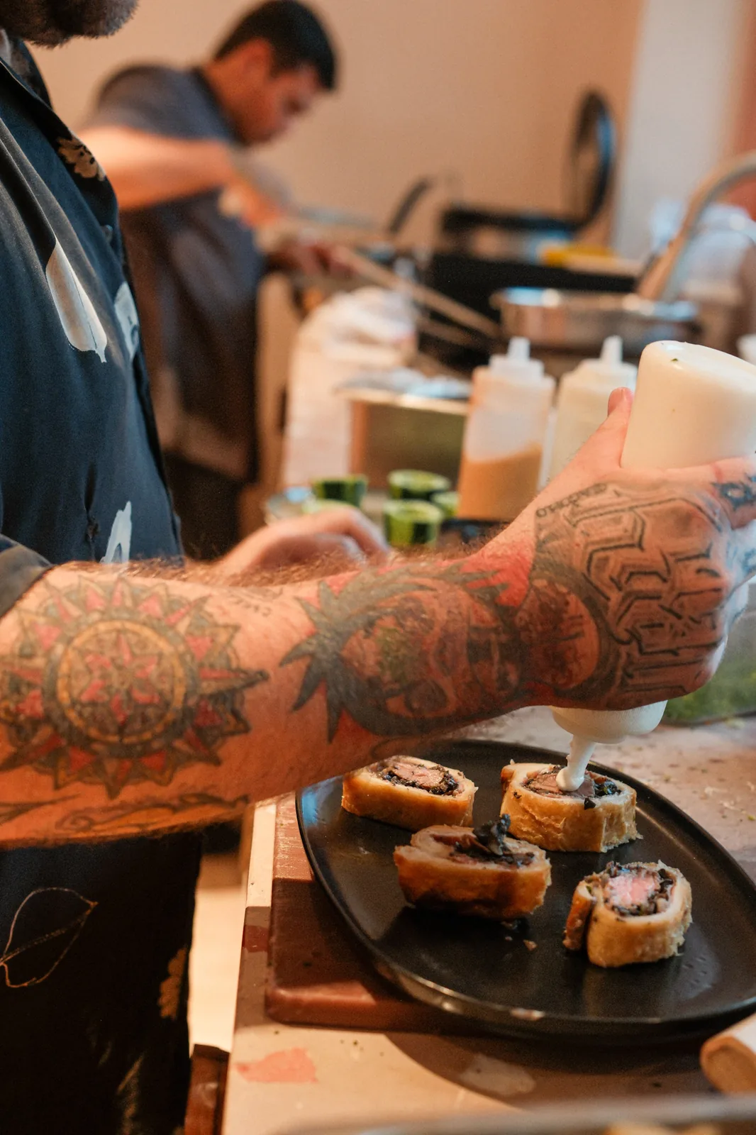 Hands plating a colorful restaurant-quality dish