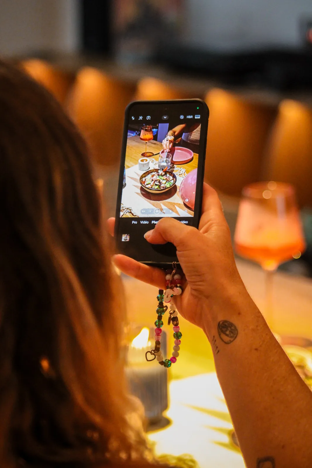 A guest photographing a beautifully plated dish